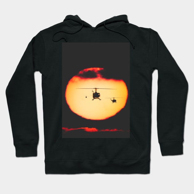 Bell Huey helicopters flying in front of the setting sun Hoodie by Pitmatic